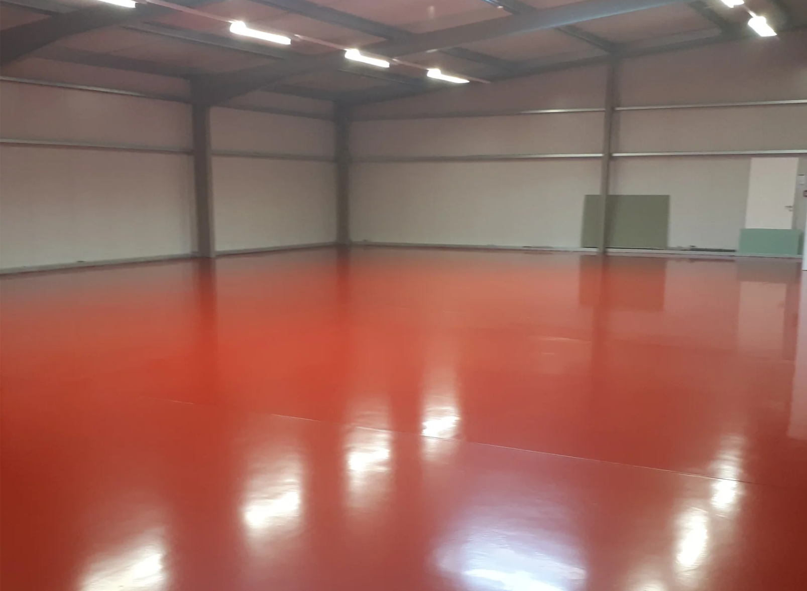 Glossy industrial epoxy flooring in warehouse